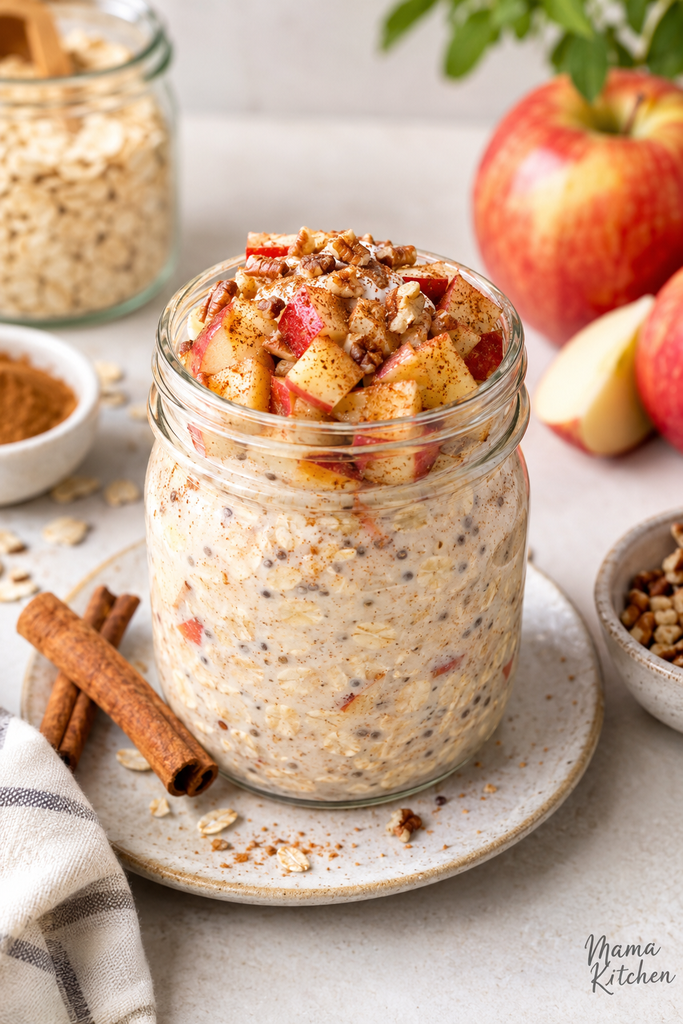 Glass jar of high protein apple pie overnight oats topped with diced apple, chopped pecans and cinnamon
